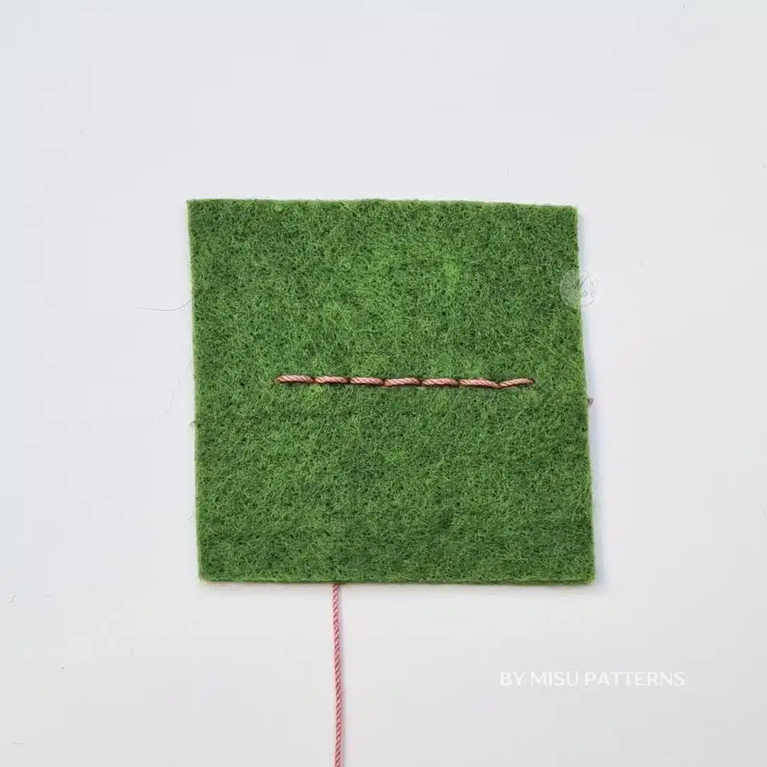 Finished backstitch on felt showing a strong, even, and continuous stitched line.