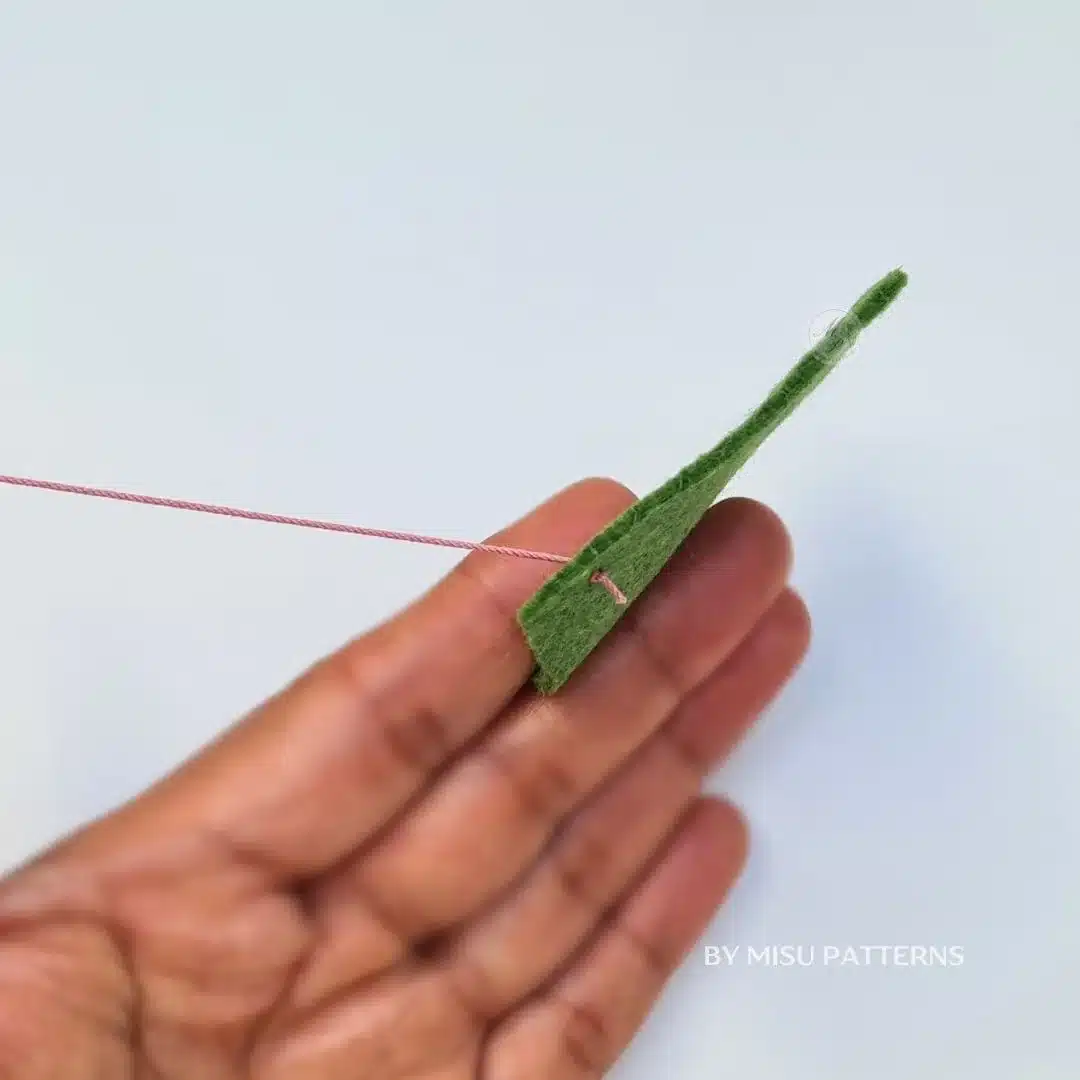 Pull carefully to make sure the knot is firm and will not pass through the fabric.