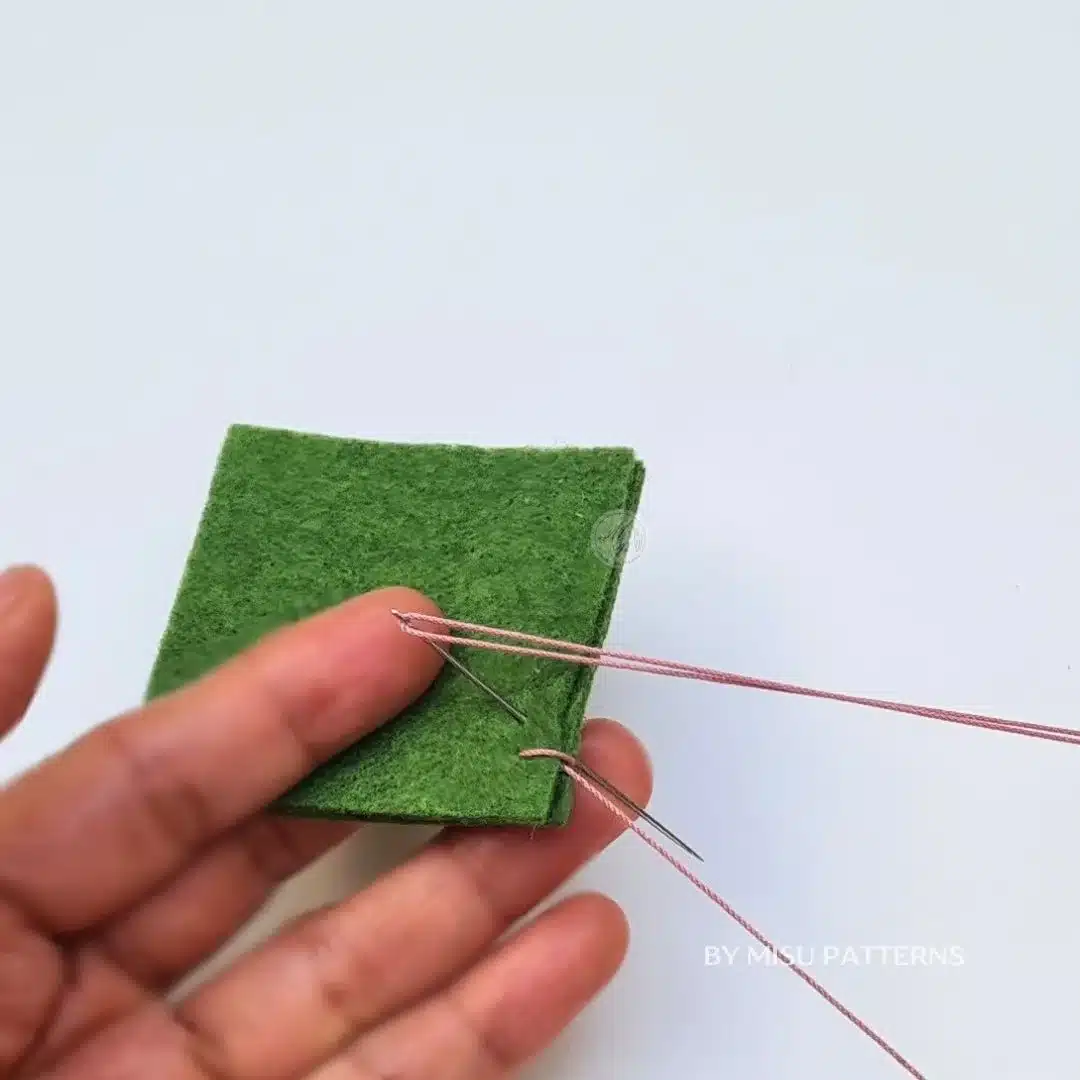 Inserting the needle from front to back 1/4 inch away from the previous blanket stitch.